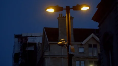 Bath City 4k CCTV camera sits under modern street lamp Stock Footage 106780894