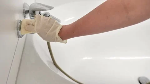 Bath cleaning. Hands cleaning and washing the bathtub in a bright bathroom Stock Footage 271593234
