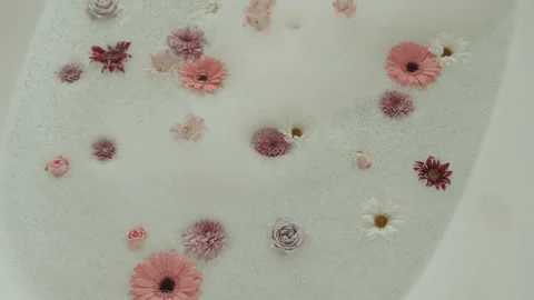 Bath With Foam And Flowers For Relaxation After Working Day, Enjoy Beauty Video stock 302282540