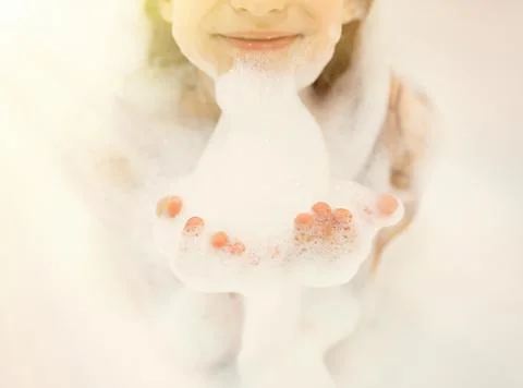 Bath foam. baby hands in bubble bath, baby washing in bubble bath Stock Photos