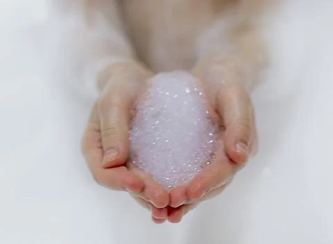 Bath foam. baby hands in bubble bath, baby washing in bubble bath Stock Photos