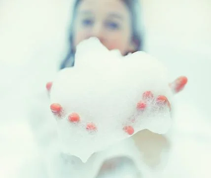 Bath foam. baby hands in bubble bath, baby washing in bubble bath Stock Photos