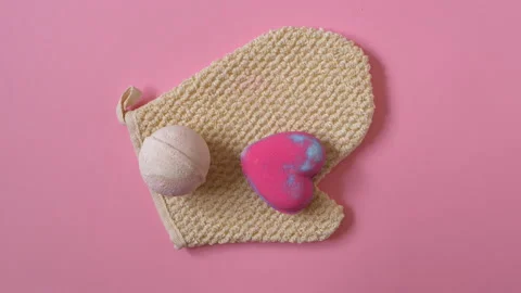 Bath routine, spa accessories appear on the pink background. Flat lay, top view. Video stock 151050011