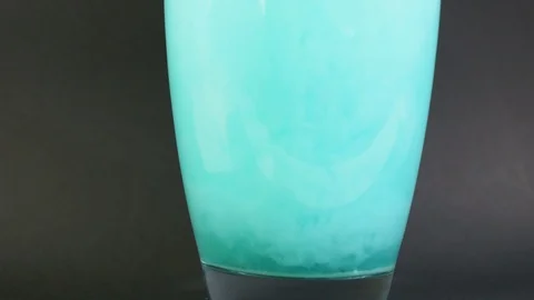 Bath salt dissolves in a vase of water in slow motion with particle drilling 4K Stock Footage 119030247