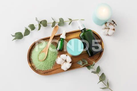 Bath salt, serum, moisturizer and oil on tray Stock Photos