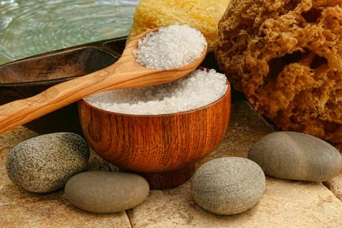 Bath salts with river rocks and sponges Stock Photos
