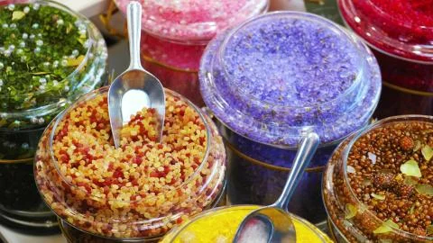Bath salts soaks closeup bathsalt in various scents in jars at shop store Stock Photos