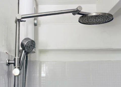 Bath shower on white tile wall Stock Photos