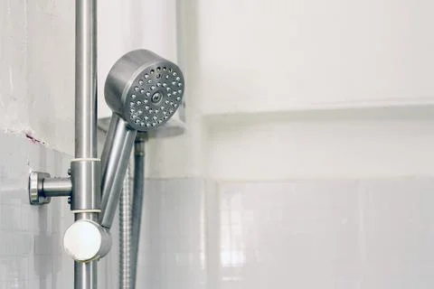 Bath shower on white tile wall Stock Photos