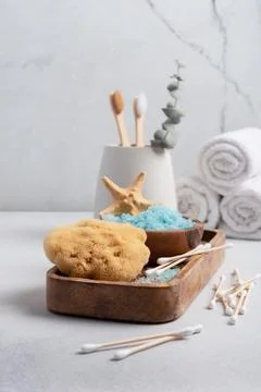 Bath Spa Setting with blue sea salt, natural wild sponge and bamboo toothbrus 库存照片