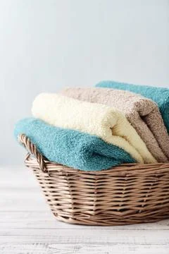 Bath towels in wicker basket Stock Photos