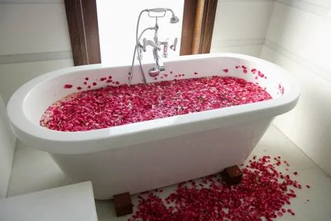 Bath tub with floating petals Stock Photos