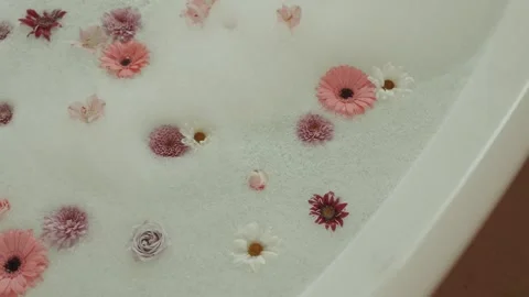 Bath With Water And Foam, Beautiful Flowers Floating On Surface, Exotic SPA Stock-Footage 344531849