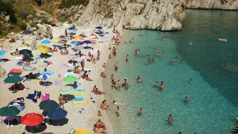 Bathers on the beach having fun in crystalline water footage 4k Stock Footage 109549503