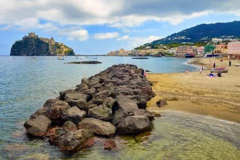 Bathers on the beach of Ischia with the Aragonese Castle in the background Stock Photos
