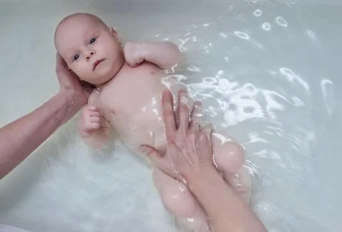 Bathing baby in the bath Stock Photos