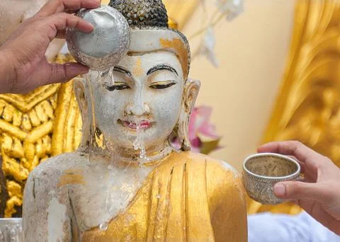 BATHING BUDDHA STATUE FOR BLESSING – A RELIGIOUS RITUAL. Stock Photos