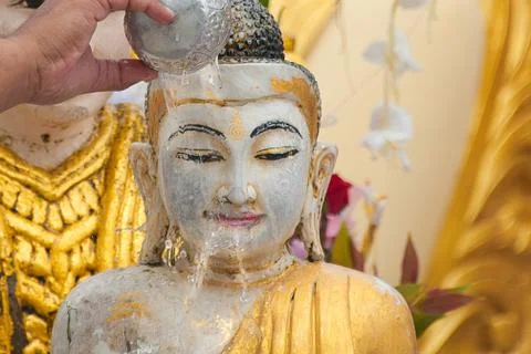BATHING BUDDHA STATUE FOR BLESSING – A RELIGIOUS RITUAL. Stock Photos