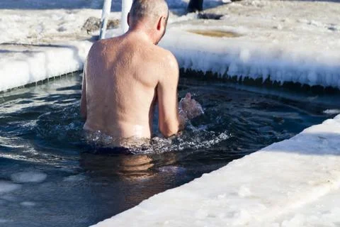 Bathing in an ice-hole Stock Photos