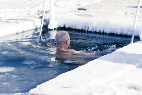 Bathing in an ice-hole Stock Photos