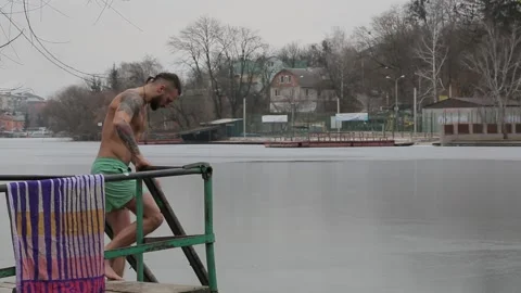 Bathing in icy water. Diving into icy water. Ice Swimming. Stock Footage 227151702