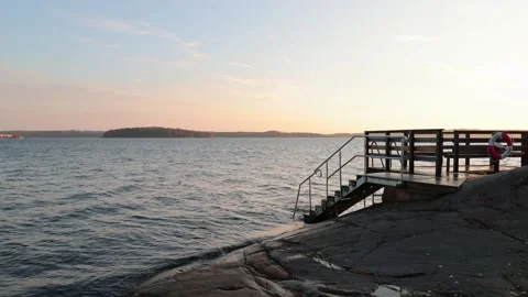 Bathing jetty on the Swedish coast in the Baltic Sea at sunrise Stock Footage 142170656