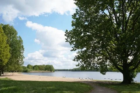 Bathing lake with empty beach in spring Stock Photos