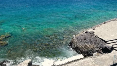Bathing site of La Caleta, El Hierro, with blue sea and a snorkeling person. Stock Footage 180103102