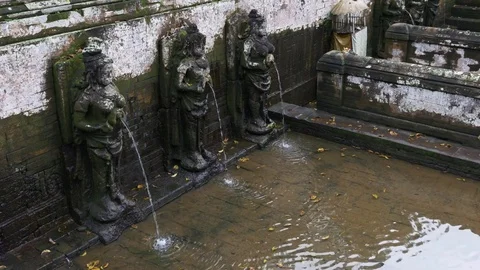 Bathing temple figures at Goa Gajah Elephant cave in Ubud Bali Video stock 84640581