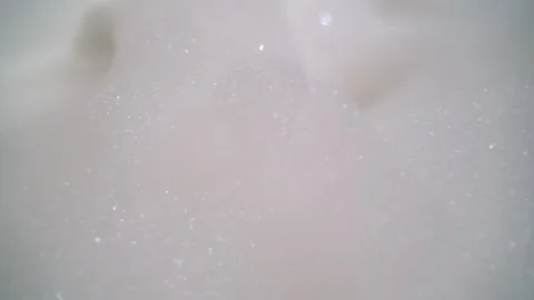 Bathroom bath foam in bathtub bubbles on top of water white bubble bath closeup Stock Footage 138743434