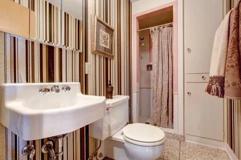 Bathroom with brown stripped wallpaper Stock Photos