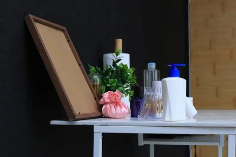Bathroom counter essentials with decorative items and a blank picture frame Фото