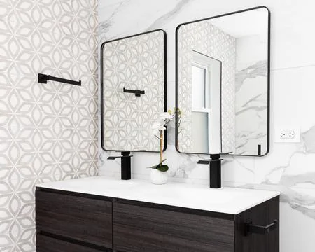 A bathroom detail with pattern and marble tile walls. Stock Photos