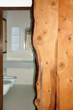Bathroom door made of natural solid wood, loft style Stock Photos