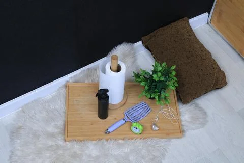 Bathroom essentials arranged on a tray with a fluffy rug and decorative pillo Stock Photos