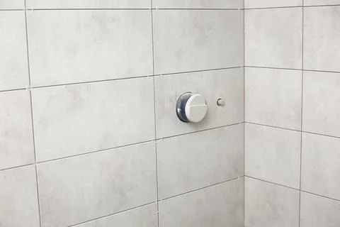 Bathroom gray tiles with neat rectangular patterns and built-in shower. Bathr Stock Photos