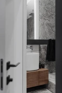 Bathroom in grey tones, stylish in modern design, dark wooden tumble, glass and Stock Photos