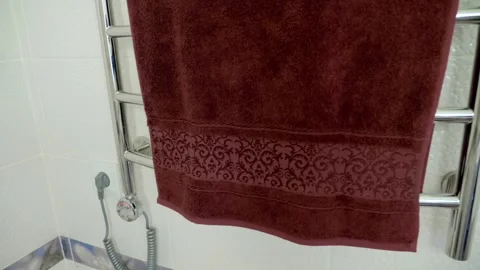 In the bathroom, hangs a modern, chrome-plated, electric heated towel rail  Stock Footage 297791926