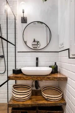 Bathroom interior with black frames, round mirror and classic white tiles Photos