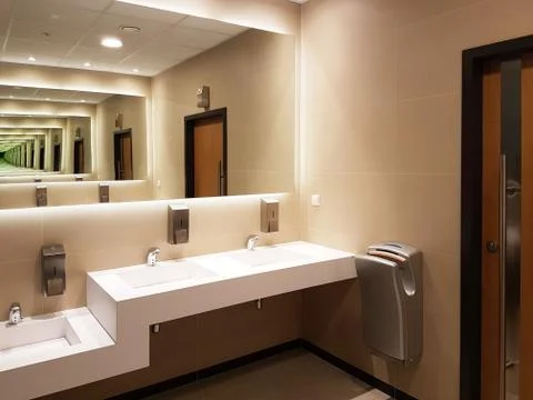 Bathroom interior in light beige and white colors. Round ceramic washbasins.  Stock Photos