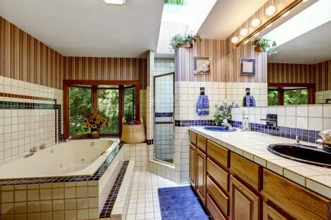 Bathroom interior with wallpaper and tile trim Stock Photos