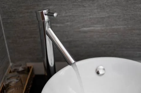 Bathroom interior with white round sink and chrome faucet in a modern bathroom Stock Photos