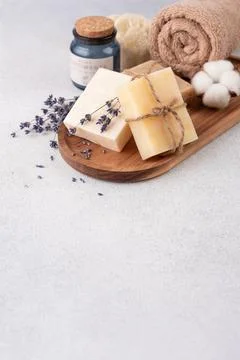 Bathroom items with crafted bars of soap, towel and aroma candle on wooden tr Foto stock