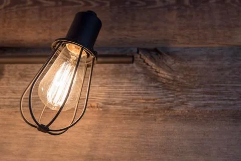 Bathroom lighting with rustic light bulb cage on background of weathered wood Stock Photos