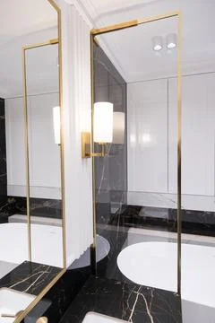 A bathroom with marble and stacked vertical subway tiles, a white oak vanit.. Fotos de archivo