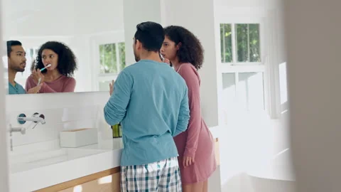 Bathroom, mirror and talking couple brush teeth with tooth whitening toothpaste Stock Footage 250091878