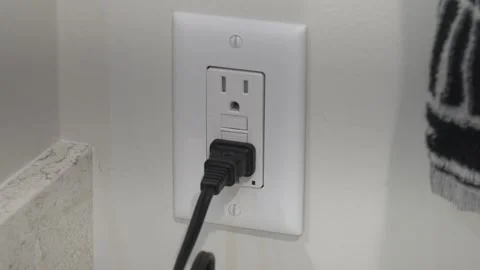 A bathroom overload electrical socket with cord attached. Stock Footage 313057858