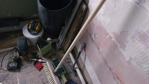 Bathroom renovation; orbit shot looking down on DIY tools in stripped back room Stock Footage 328567090