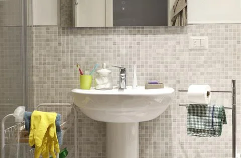 Bathroom renovation work with ceramic mosaic tiles wall background. Stock Photos