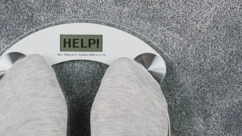 Bathroom scales with LCD screen saying Help Stock Footage 149359022